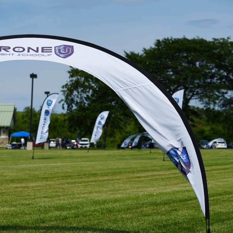 Drone U Flight School gate and flags lining a training field used for standardized drills when scaling a drone program