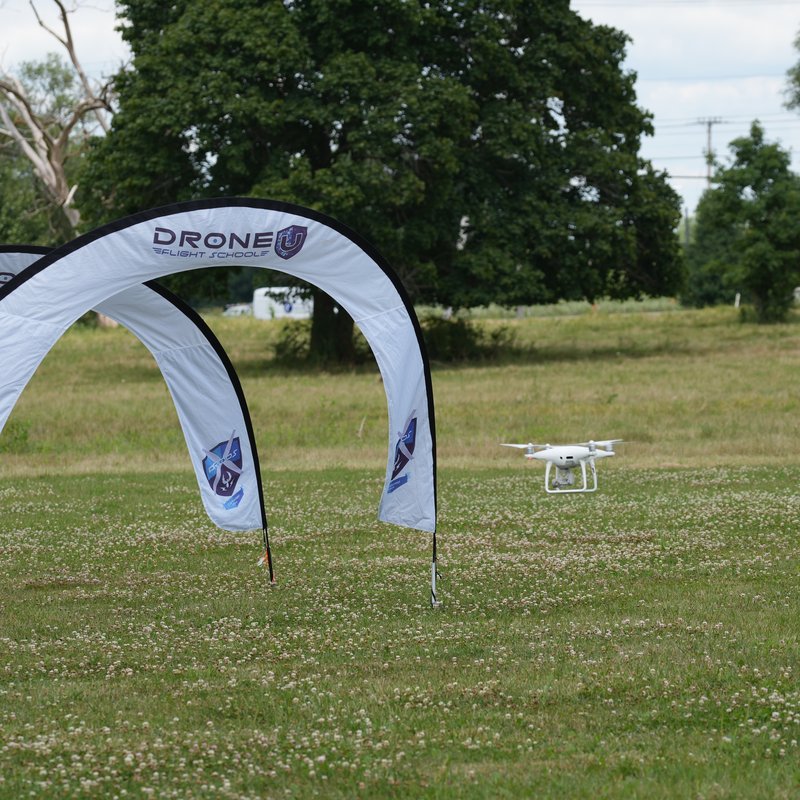 Drones in the workforce - Phantom drone flying through Drone U Flight School training gates