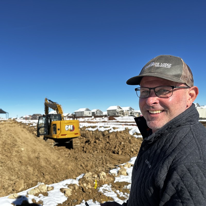 How to become a drone pilot on the mapping path: pilot at an earthmoving construction site with a CAT excavator