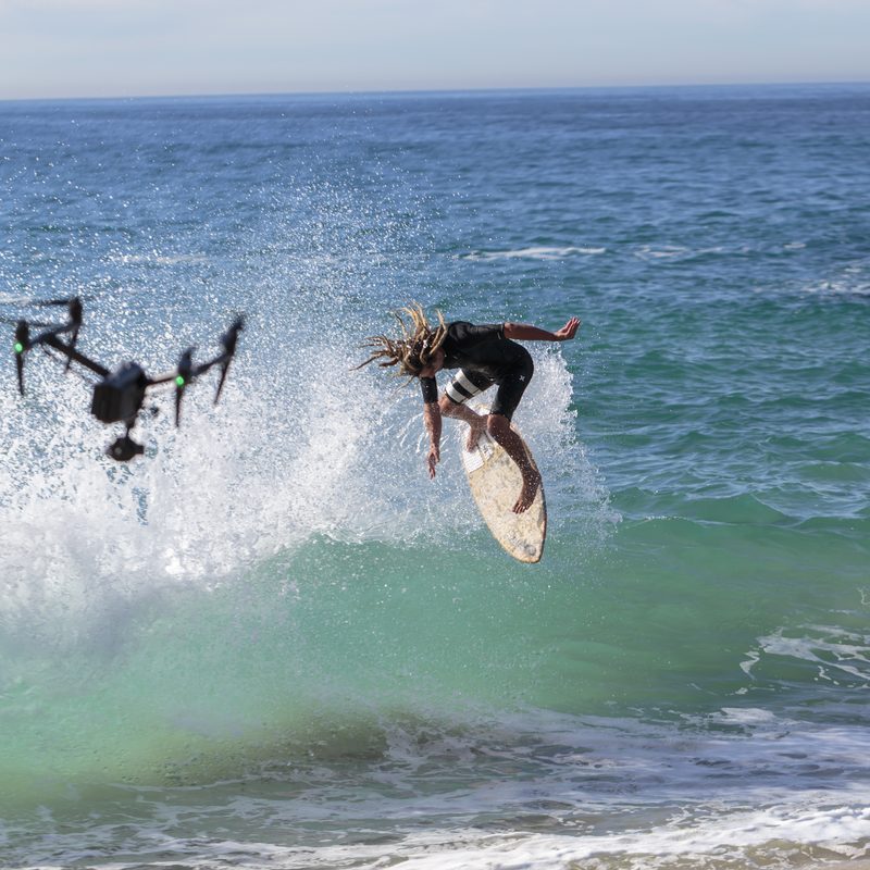 What is a drone used for - drone filming a surfer catching air